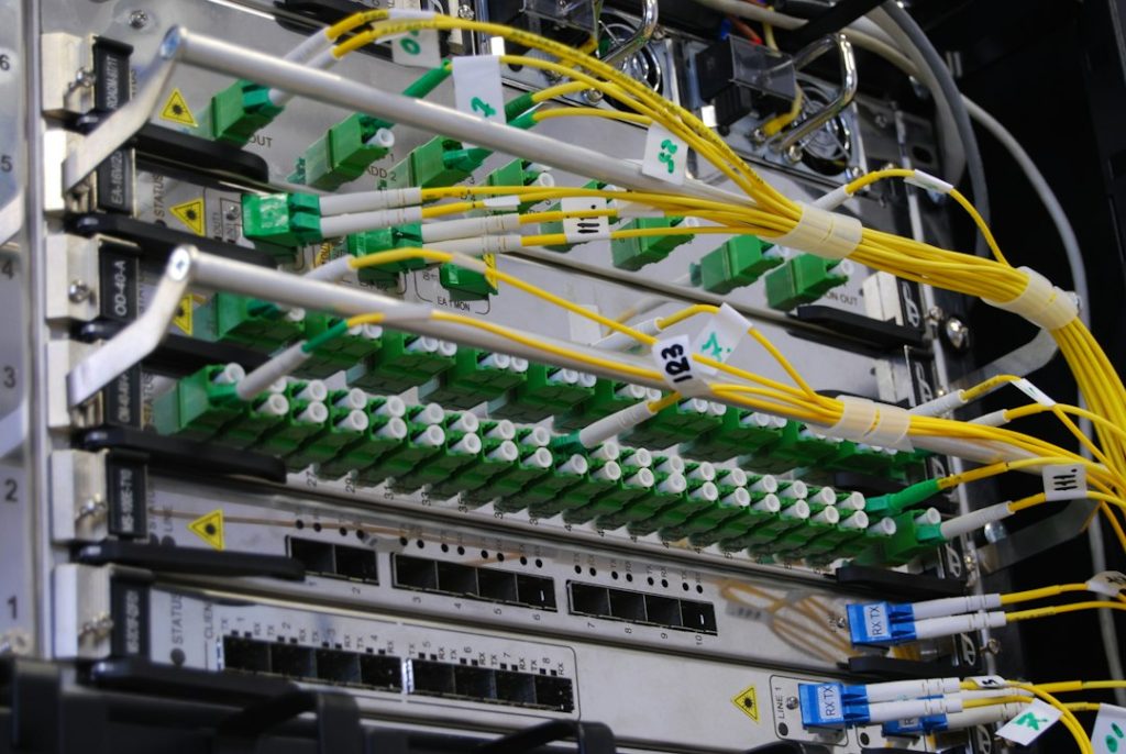 Fiber optic network rack showing equipment and fiber connections used with optical transceiver modules.